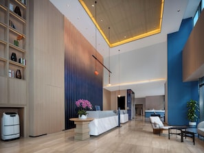 A modern hotel lobby with a reception desk, seating area, and a large window. - Holiday Inn Express Shenzhen Bay By Ihg (Shenzhen)