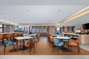 A modern restaurant with a bar area, multiple seating options, and a view of the cityscape. - Holiday Inn Express Shenzhen Bay By Ihg (Shenzhen)