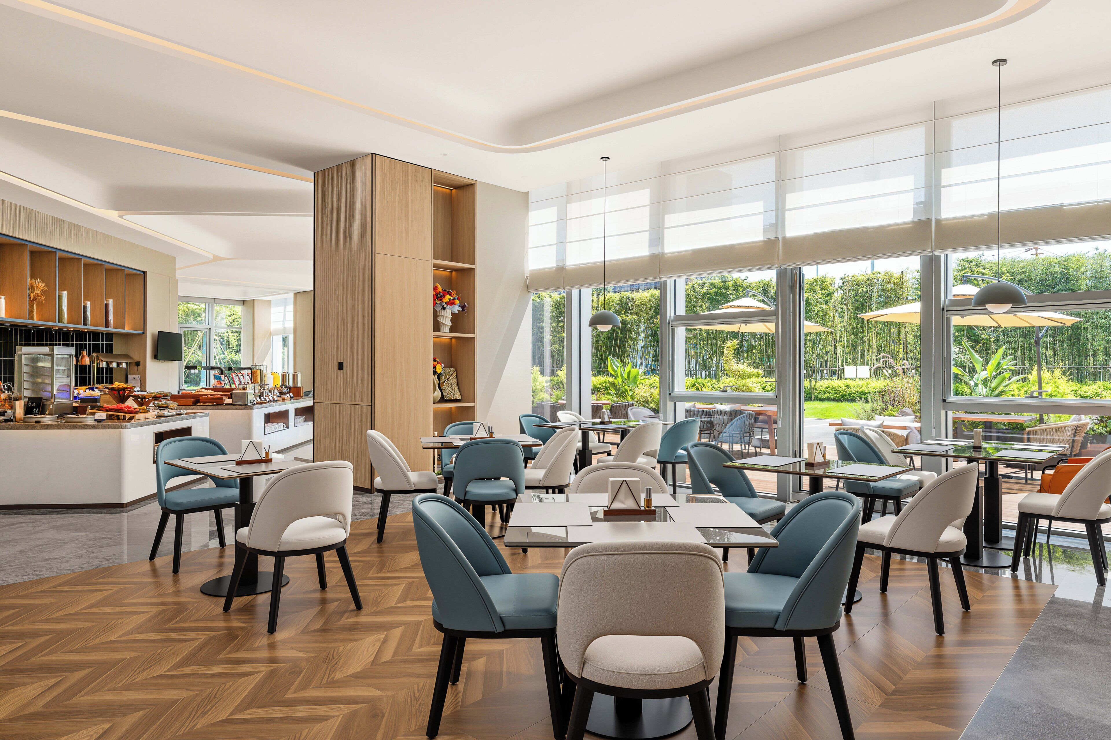 A modern dining area with a bar and seating arrangement.