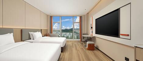 A modern hotel room with two beds, a large TV, and a city view.