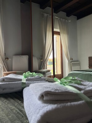 A room with a bed, a chair, and a window with curtains. - Adige View Suite (Verona)
