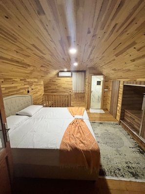 A wooden cabin bedroom with a bed, a small window, and a door. - Karatay Villas with AC and swimming pool in charming Demre (Demre)