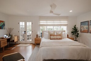 A bedroom with a bed, a desk, a chair, a plant, and a window. - 🌊 Designer Bird Rock Gem | Walk to Beach & Cafe (La Jolla)