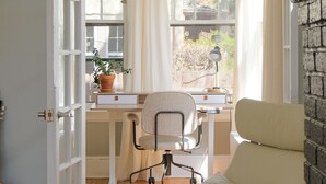 A room with a desk, chair, and a bed with a pillow. - 4BR Hygge Home | Theater + Game Room | Sleeps 10 (Minneapolis)