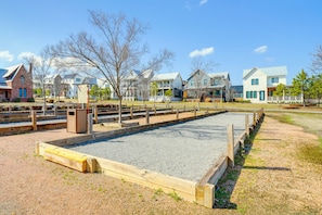 A residential area with houses, a gravel court, and wooden fences. - Boardwalk Blue in Carlton Landing (Carlton Landing)