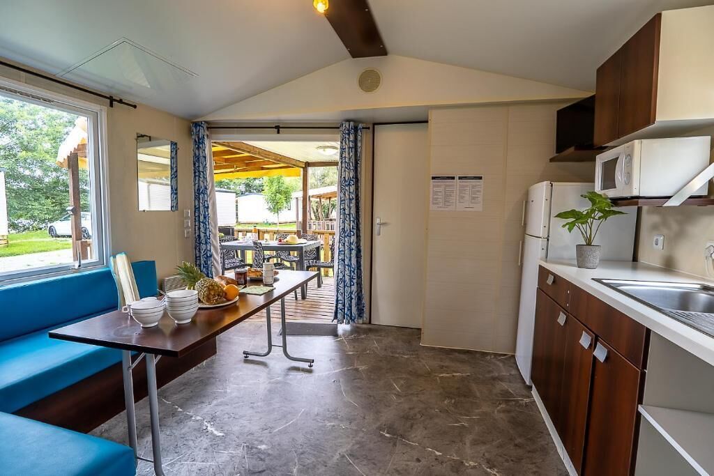 A compact kitchen with a dining area, a microwave, and a sink.