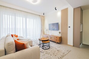 Ein modernes Wohnzimmer mit einer Couch, einem Couchtisch, einem Schrank und einem Bild an der Wand.