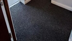 A room with a dark carpet, white walls, a door, and a window. - Fenia Estate (Barking)