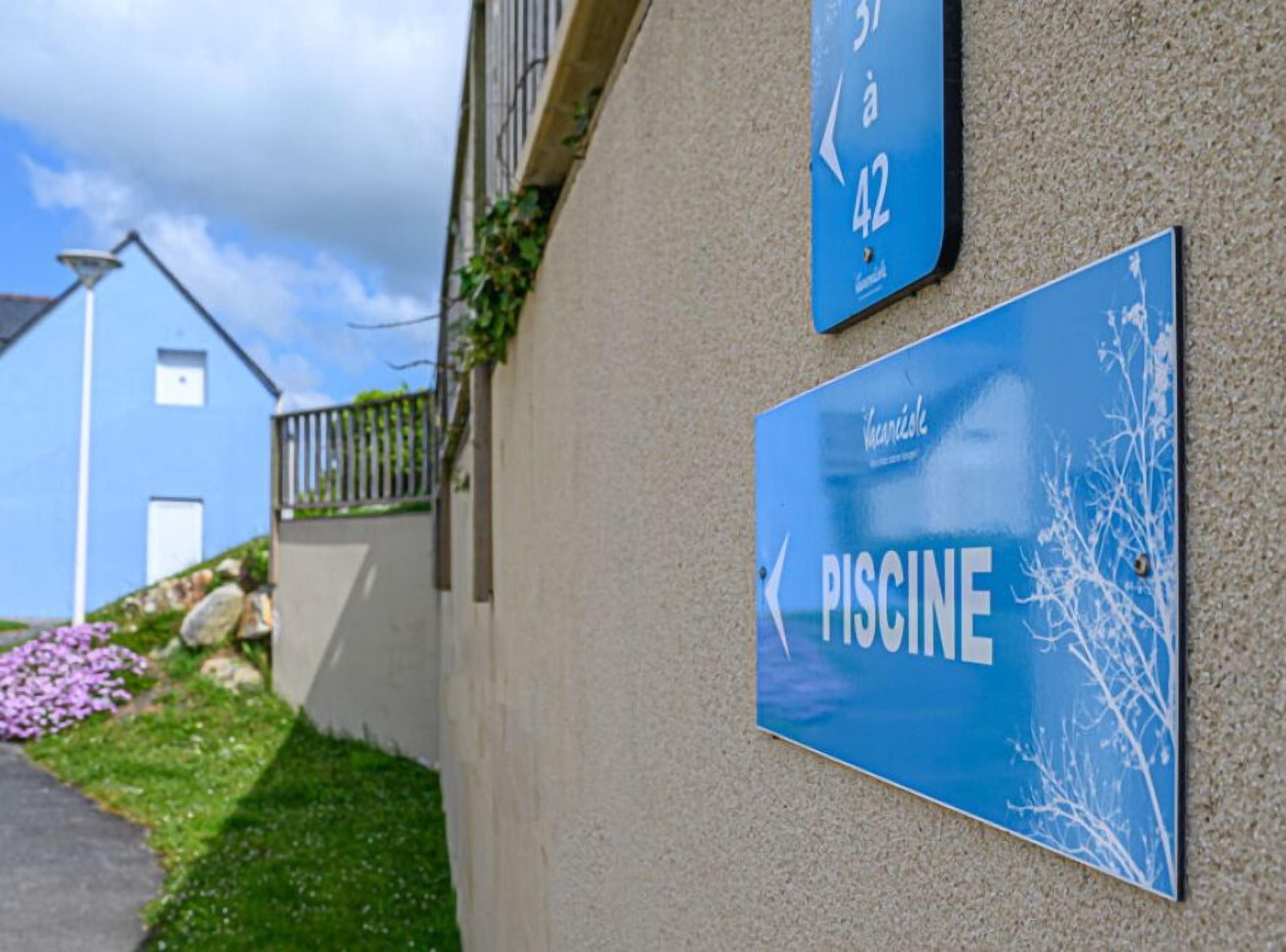 Segnaletica blu con la scritta 'PISCINE' che indica una piscina.