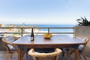 Outdoor dining - Seafront Apartment, balcony with ocean views of La Gomera and sunsets !!! (Guía de Isora)