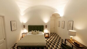 A hotel room with a bed, nightstands, a lamp, and a checkered floor. - Bambagina Mare (Amalfi)