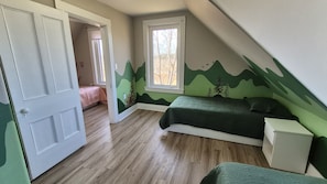 Un dormitorio con cama, mesita de noche, armario, ventana y puerta.