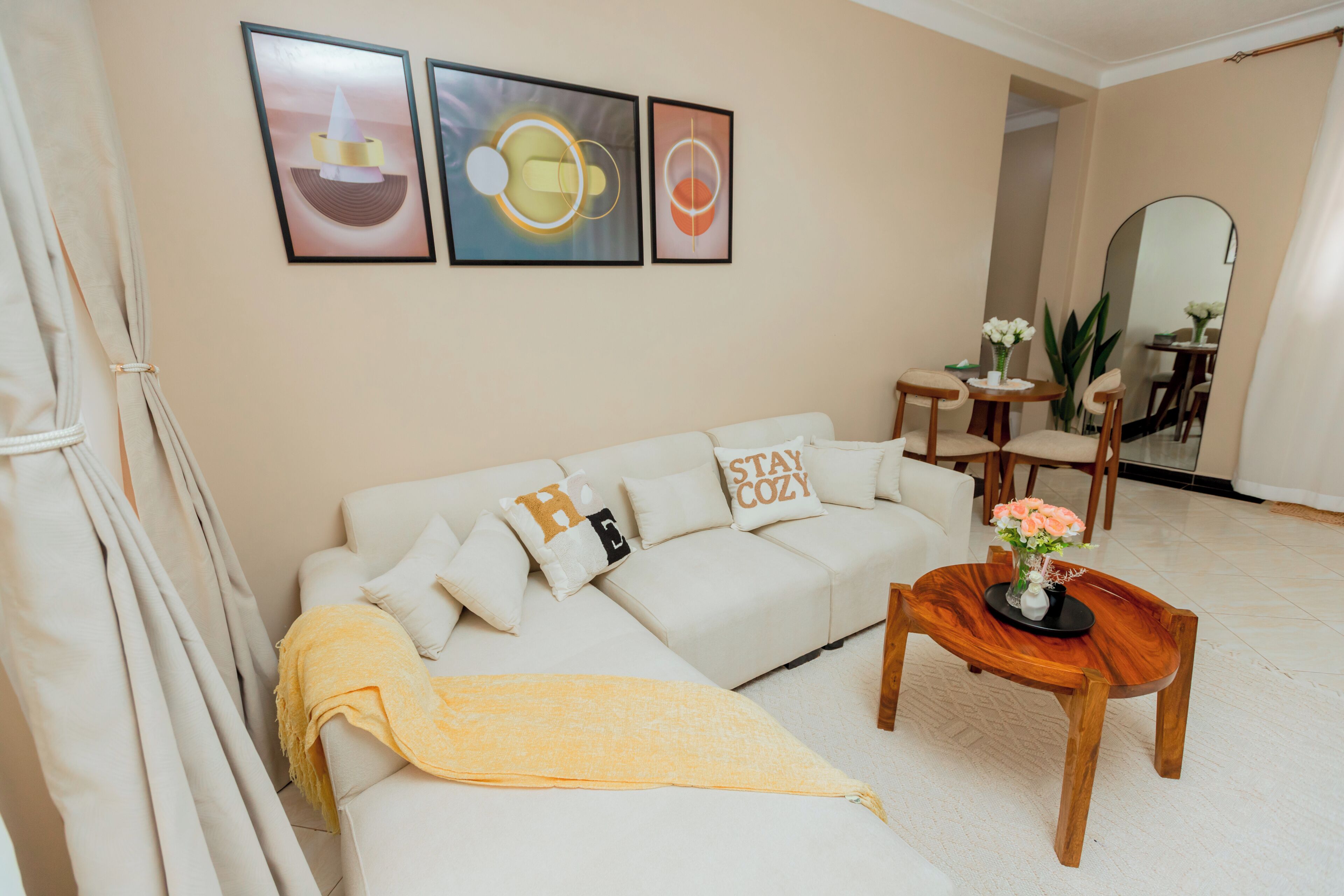 A living room with a sofa, a coffee table, and framed artwork on the wall.