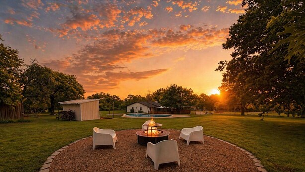 A circular outdoor seating area with a fire pit, surrounded by a gravel ring and grass. - Woodland Retreat/Pool+Patio+Firepit+SunsetViews (Weatherford)