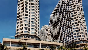 Two high-rise buildings with a clear sky. - The Trinity Mandala Seaview (Mui Ne)
