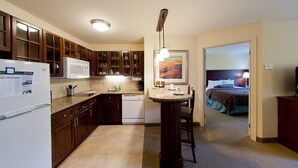 A compact hotel room with a kitchenette, a dining area, and a bed. - Poconos Suite w/ Free Breakfast & Pool (East Stroudsburg)
