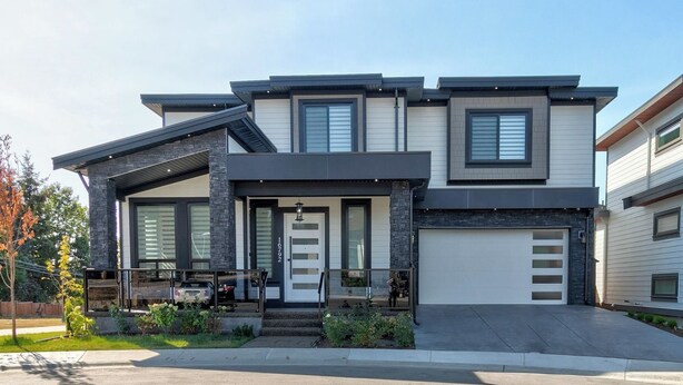 A modern two-story house with a garage, large windows, and a well-maintained front yard. - 🏡 Upscale COZY 2BR Coastal Suite  Private Entry, Laundry & Minutes to the Beach (Surrey)