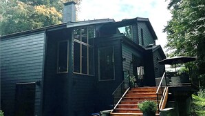 A two-story house with a staircase leading to a deck. - West Vancouver Ambelside Mid-Century Home (West Vancouver)