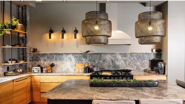 A modern kitchen with a marble countertop, wooden cabinets, a gas stove, and pendant lights. - West Vancouver Ambelside Mid-Century Home (West Vancouver)