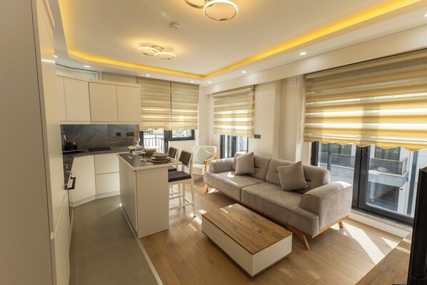 Departamento Confort, balcón | Área de sala de estar