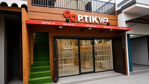 A storefront with a wooden facade and a glass entrance. - Hotel O near Universitas Sumatera Utara  (Medan)