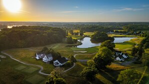 A golf course with water hazards, surrounded by residential houses.