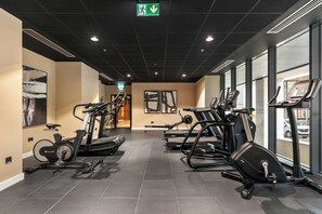 A gym with stationary bikes, treadmills, and elliptical machines. - Apex Executive Apartments- The Ironworks (Dublin)