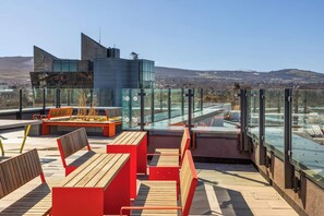 A rooftop terrace with seating, a glass railing, and a view of the landscape. - Apex Executive Apartments- The Ironworks (Dublin)