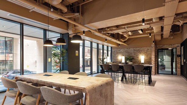 A modern conference room with a large table, chairs, and pendant lighting. - Apex Executive Apartments- The Ironworks (Dublin)