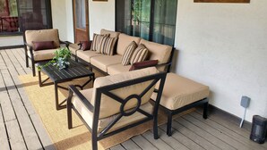 A covered outdoor seating area with a sofa, chairs, and a table. - Welcoming 2-bedroom house with AC in charming San Simon (San Simon)