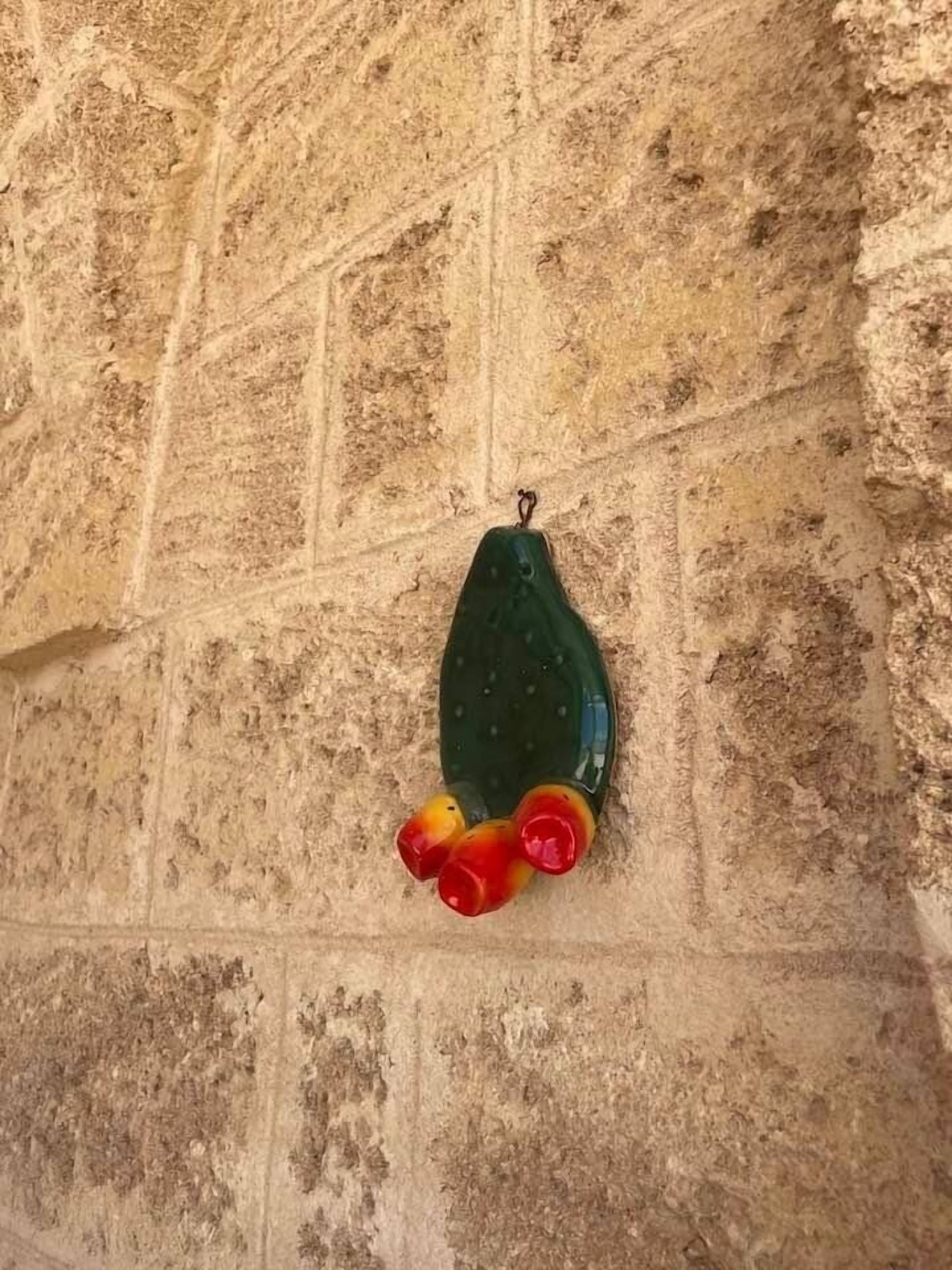A textured wall with a hanging object.