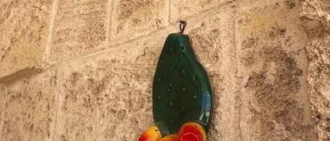 A textured wall with a hanging object.