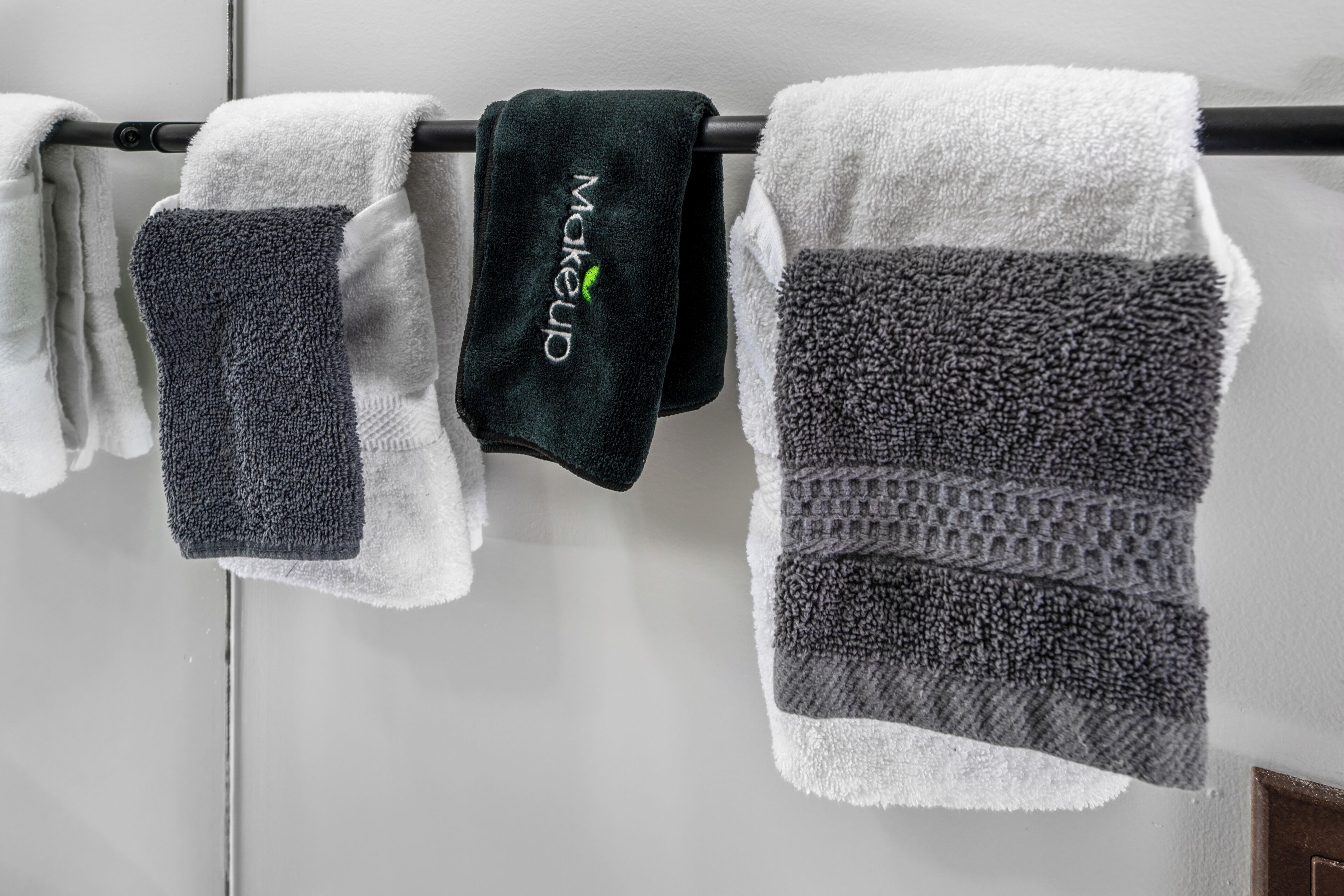 A row of towels hanging on a rack.
