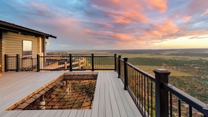 A wooden deck with a view of a valley and a sunset sky. - Elevation40Zion (Apple Valley)