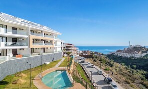 A modern hotel with a swimming pool, multiple balconies, and a view of the sea. - Infinity View by HWPC (Fuengirola)