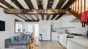 A modern kitchen with white cabinets, a gas stove, and a built-in oven. - The Beatles Inspired 3BDR Home by Abbey Road (Greater London)