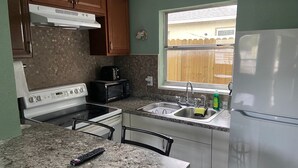 A kitchen with a stove, microwave, sink, and refrigerator. - Downtown Sarasota Rental, 2 Units,4 Bedrooms,3 Baths, Sleeps 10, Lido Beach 6min (Sarasota)