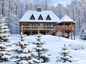 A large wooden cabin with a balcony and a gazebo, surrounded by snow-covered trees. - Hilltop Cabin overlooking Moosehead Lake (Greenville)
