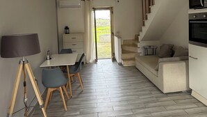 Un intérieur moderne comprenant un coin repas, un escalier et une cuisine.