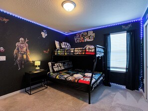 A Star Wars-themed bedroom with a bunk bed, wall decorations, and LED strip lights. - Dream Home 7BR – Pool, Hot Tub, Game Room & Theater - Near Disney! (Davenport)