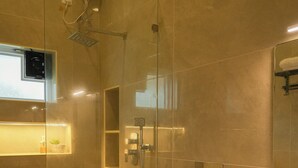 A modern bathroom with a glass-enclosed shower, a white toilet, and a large sink. - River Suite with River View (Kochi)