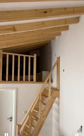 A wooden staircase leading to an upper level with a view of the interior space below. - Relaxing refuge by the River Alva (Santo António de Alva)