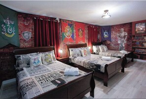 A room with two wooden beds, red curtains, and a brick wall adorned with various flags. - Spacious family getaway in Champions Gate Resort (Davenport)