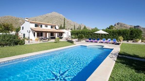 A pool with a mountain backdrop, a white building with a tiled roof, and lounge chairs. - Stylish Retreat, A/C, Private Pool - Walking Distance (15mins) to Port de Pollenca & Beach! (Pollença)