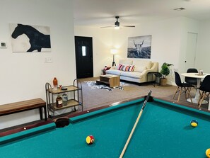 A pool table in a living room with a sofa and a lamp. - Spacious 2BR Guest House - Perfect for Remote Work, Family and Pet-Friendly (Las Vegas)
