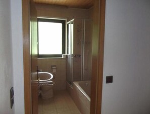 Ein Badezimmer mit Toilette, Waschbecken und Dusche.