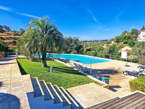 A swimming pool with lounge chairs, a palm tree, and a staircase leading to a deck. - Terras Novas Village Paradise By BeCherish (Albufeira)