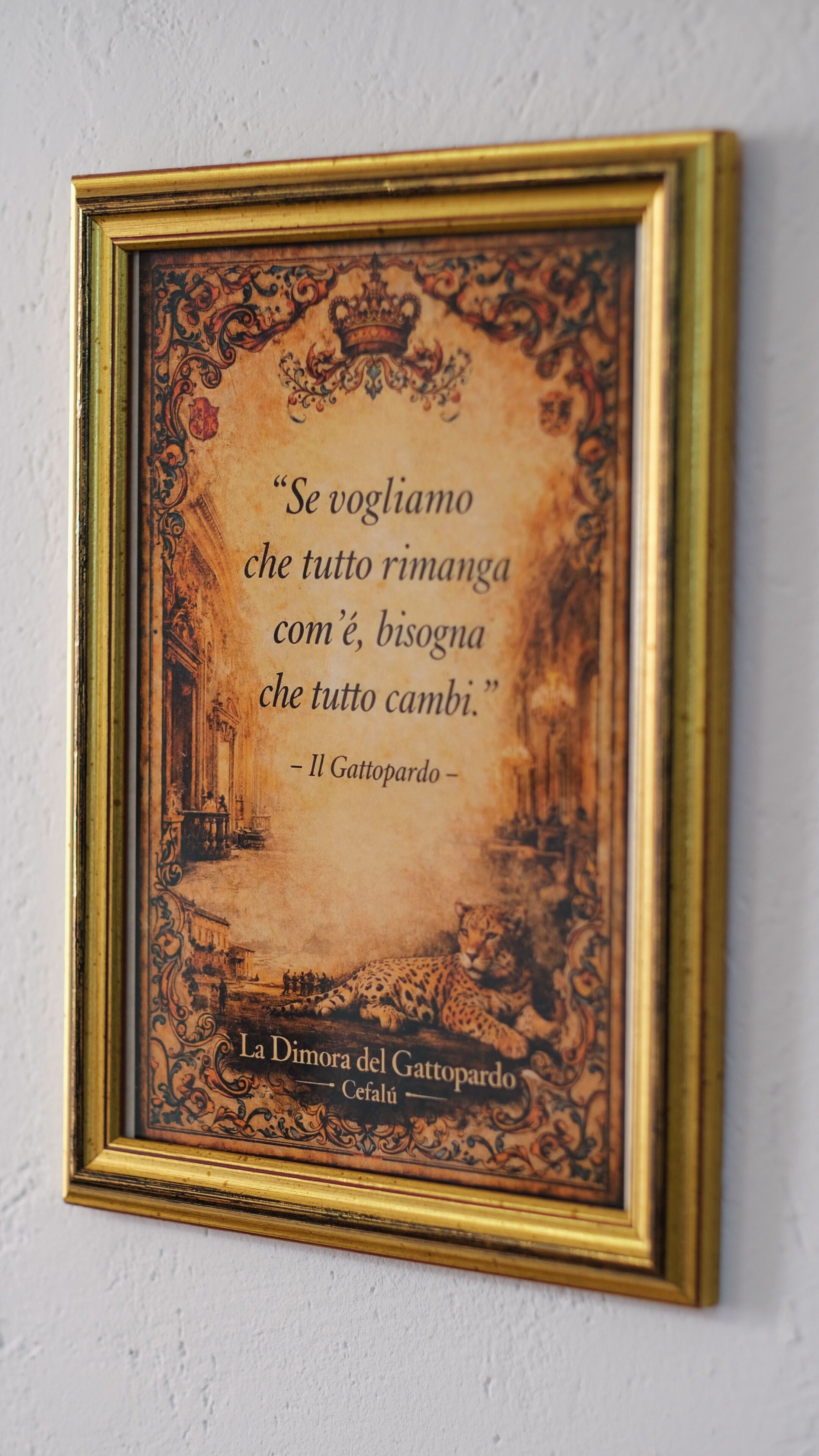 A framed quote with ornate borders and a classical building illustration.