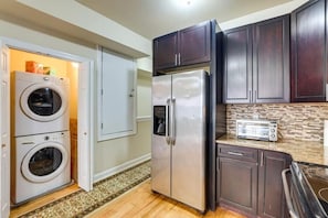 A compact kitchen with a stainless steel refrigerator, a built-in oven, a toaster, and a washing machine. - 4B/2B Apt in Philadelphia, FIFA World Cup 2026 - 15 minutes away (Philadelphia)