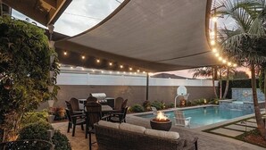 An outdoor patio with a pool, a fire pit, and outdoor furniture. - 3 bedroom & 2 bathroom home in Glendora, CA with a pool and spa/hot tub (Glendora)